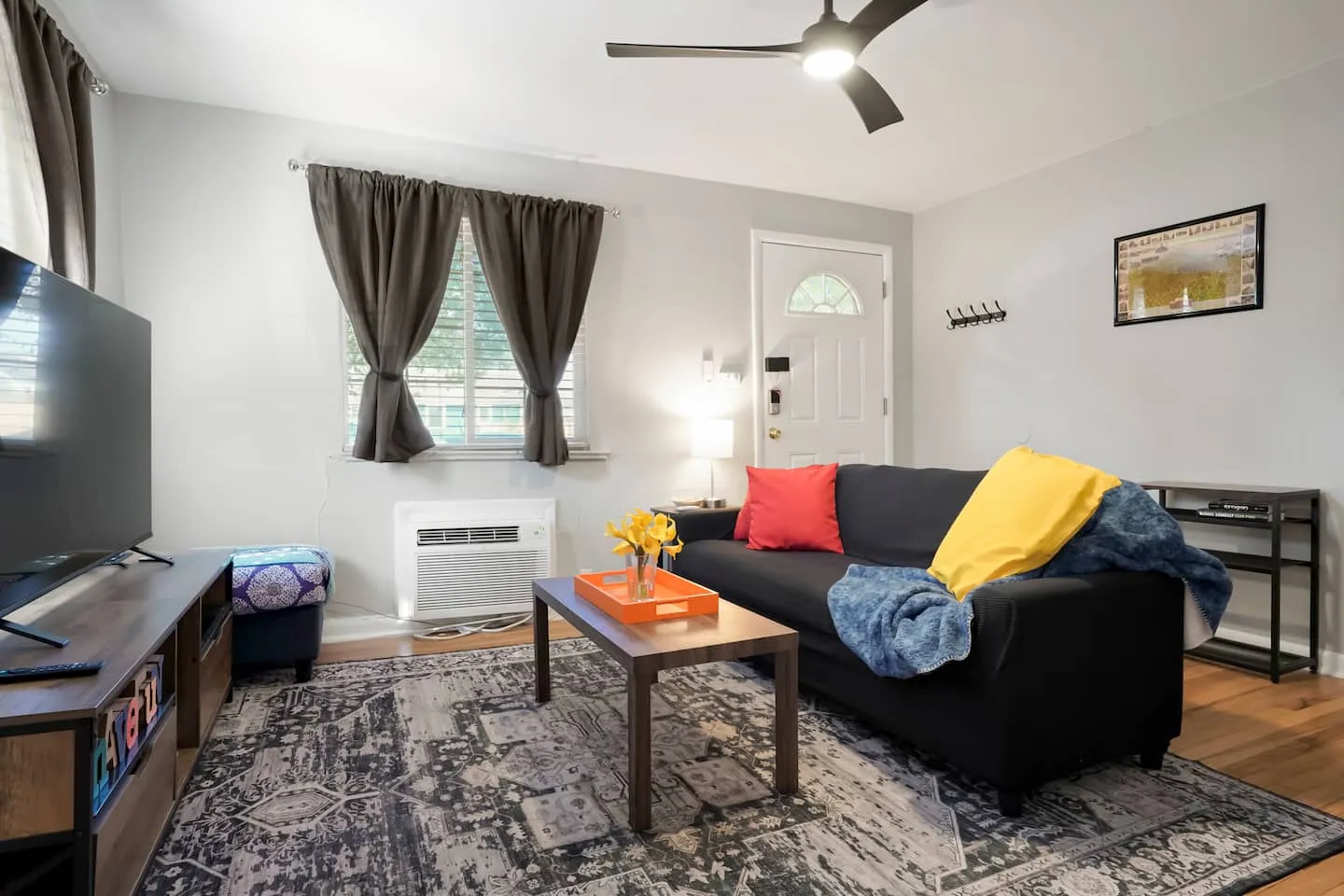 Sofa, coffee table, and wall AC unit