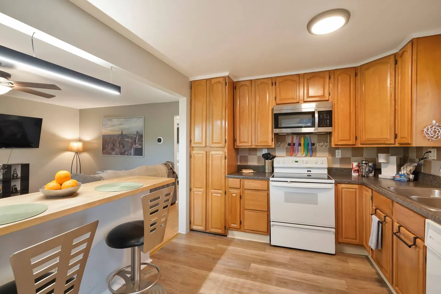 Kitchen with wood cabinets and breakfast-bar seating
