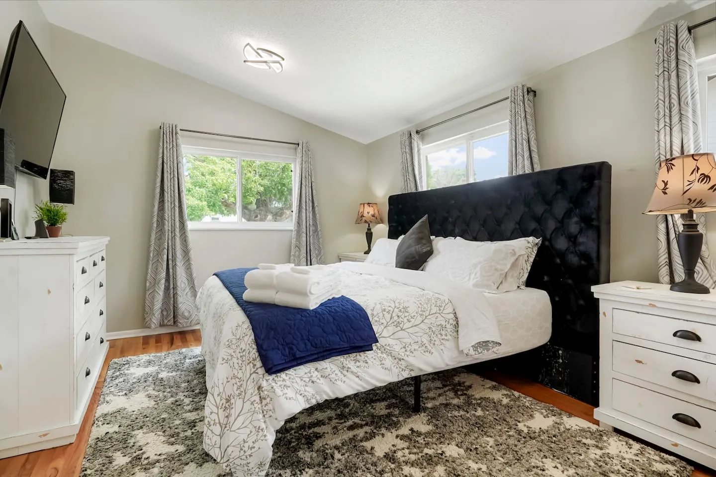 Primary bedroom with a king bed and vaulted ceiling