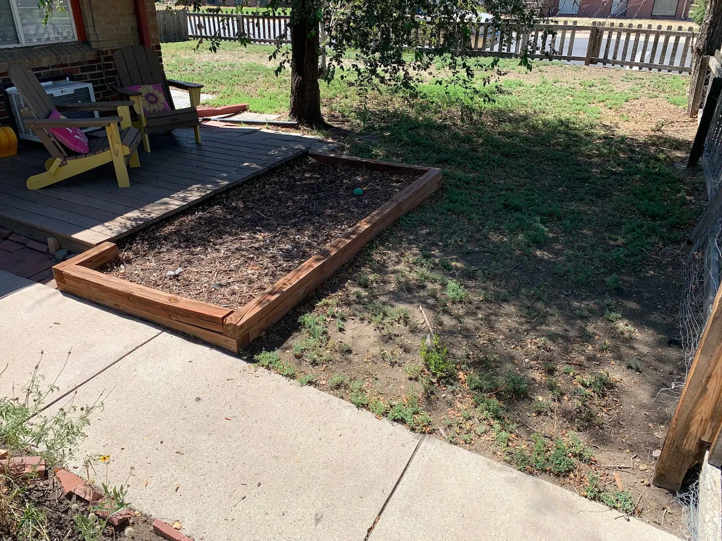 Deck and garden bed at the corner of the yard