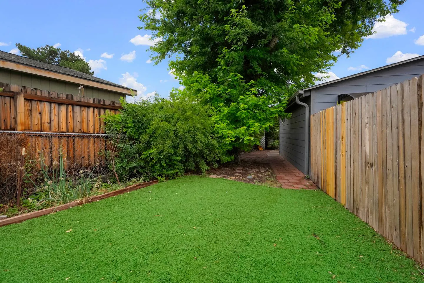 Long fenced side yard with six-foot fencing