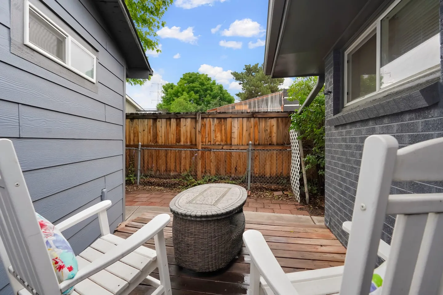 Private patio alcove with white rocking chairs