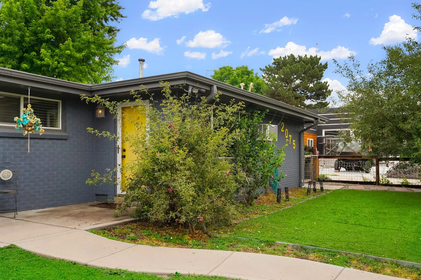 The yellow front door and front garden
